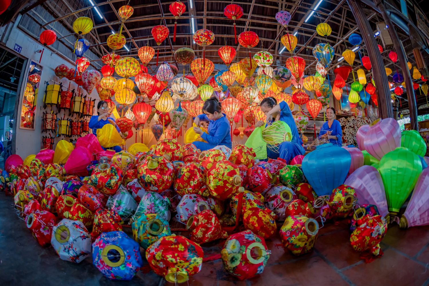 Workers assembling traditional Vietnamese lanterns in a craft workshop