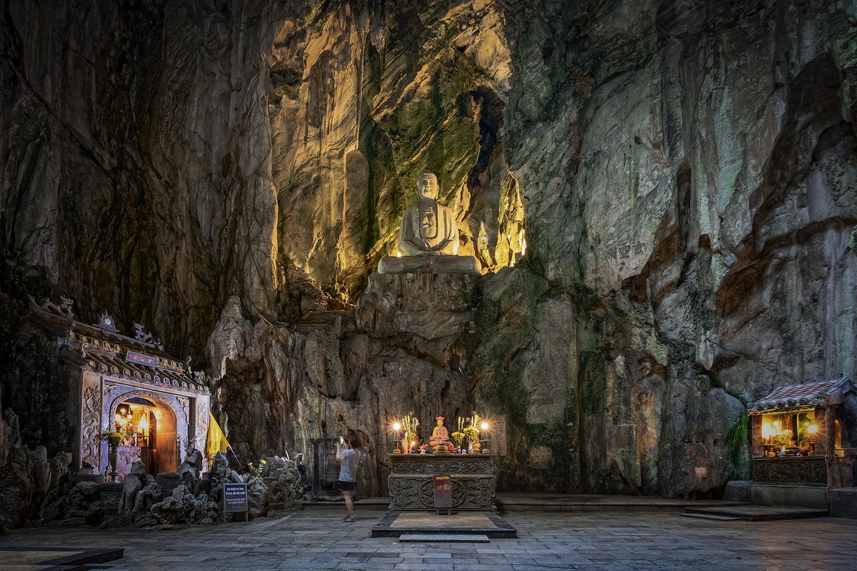 Temple roofs and a green limestone hill on Thuy Son in the Marble Mountains, Da Nang.