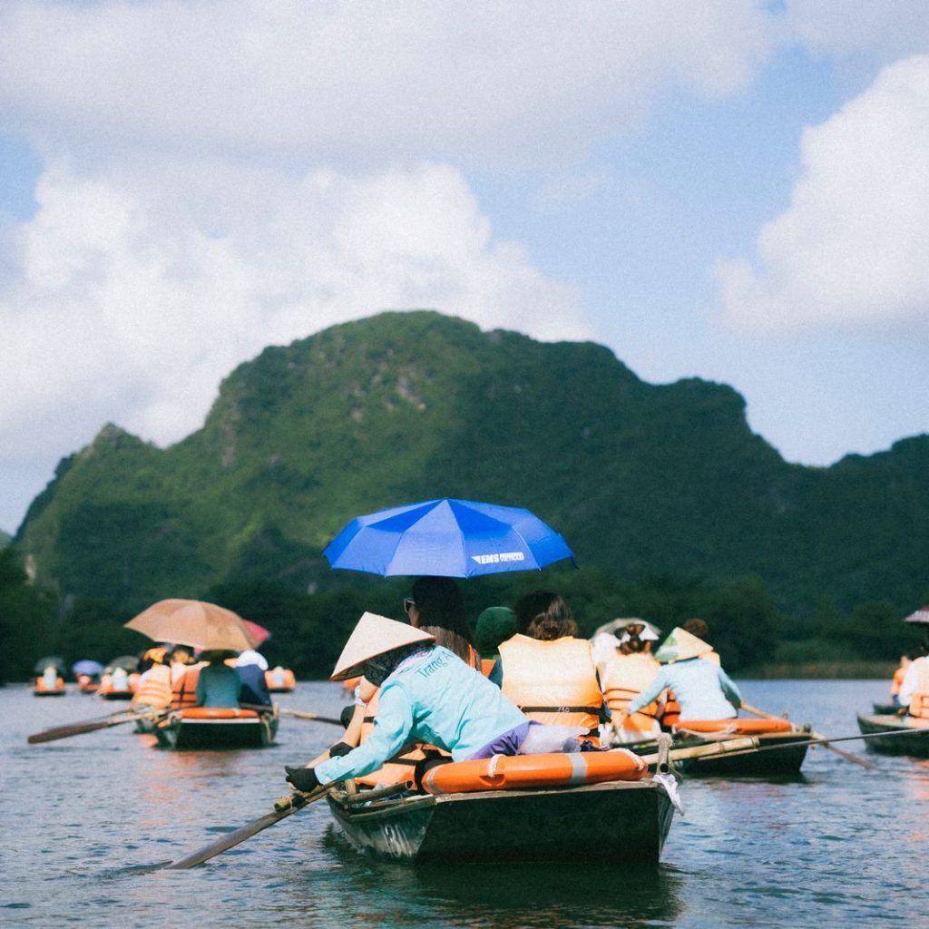 Riverboats beneath limestone karsts in Ninh Binh, Vietnam