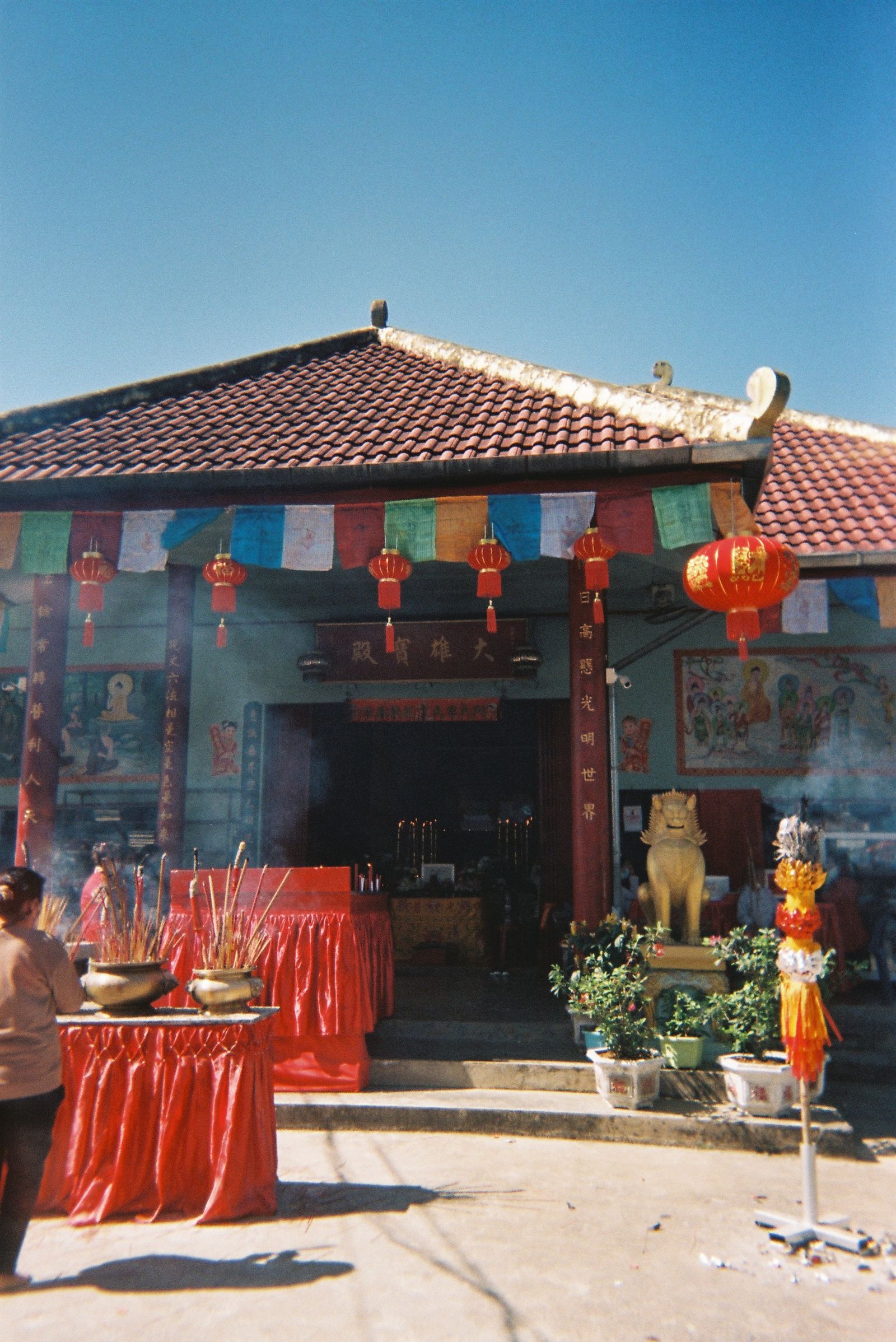 Colorful Vietnamese Buddhist temple entrance with incense
