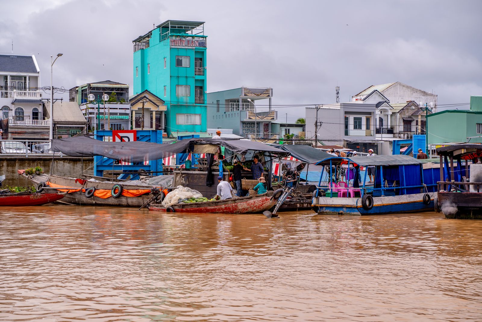 Colorful trading boats laden with melons clustered together at the Can Tho floating market on the Mekong River