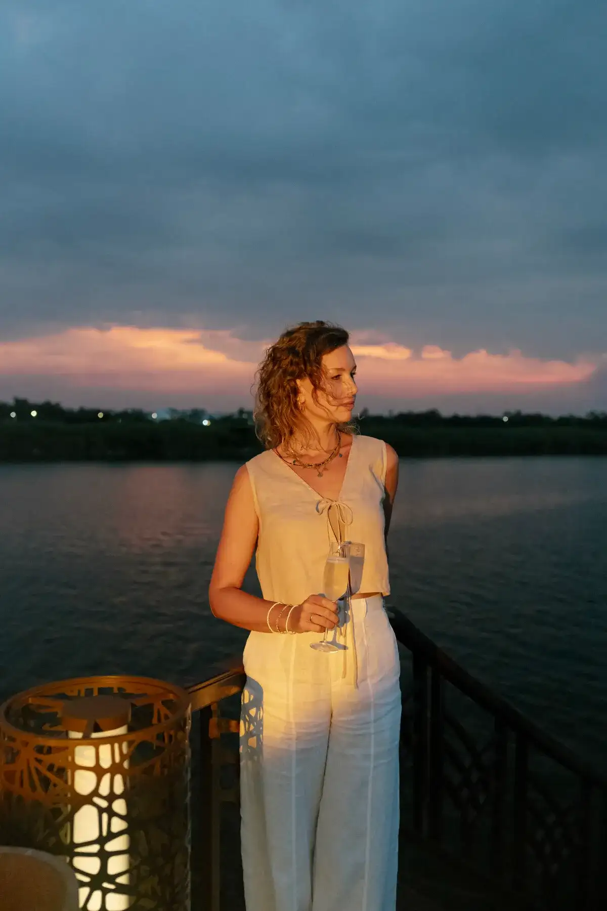woman champagne river cruise sunset