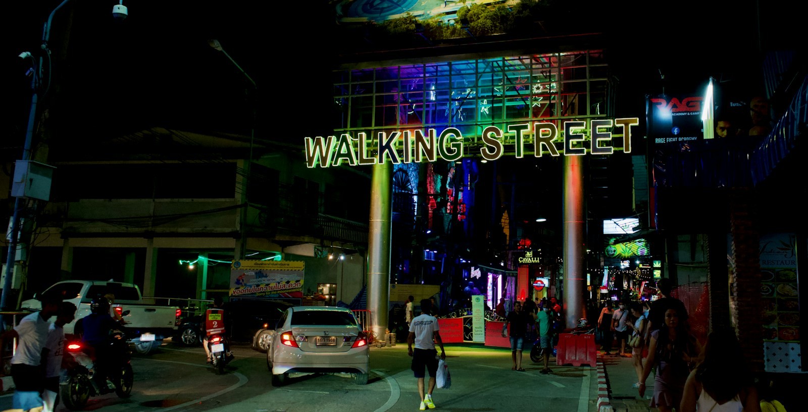Illuminated Walking Street entrance sign in Pattaya at night