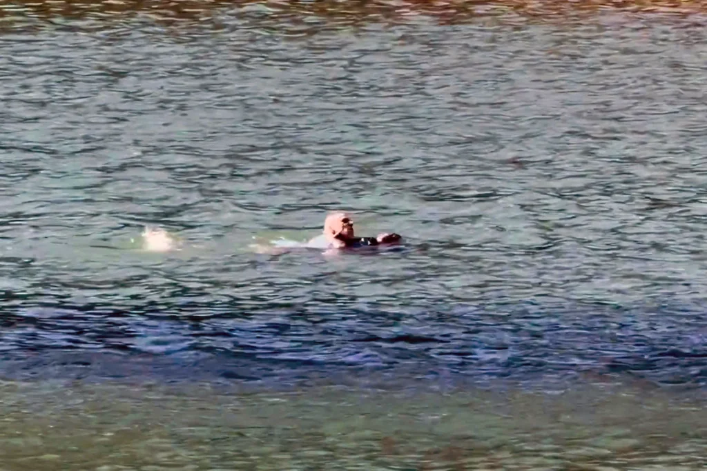 Two people in the water at Tuyen Lam Lake.