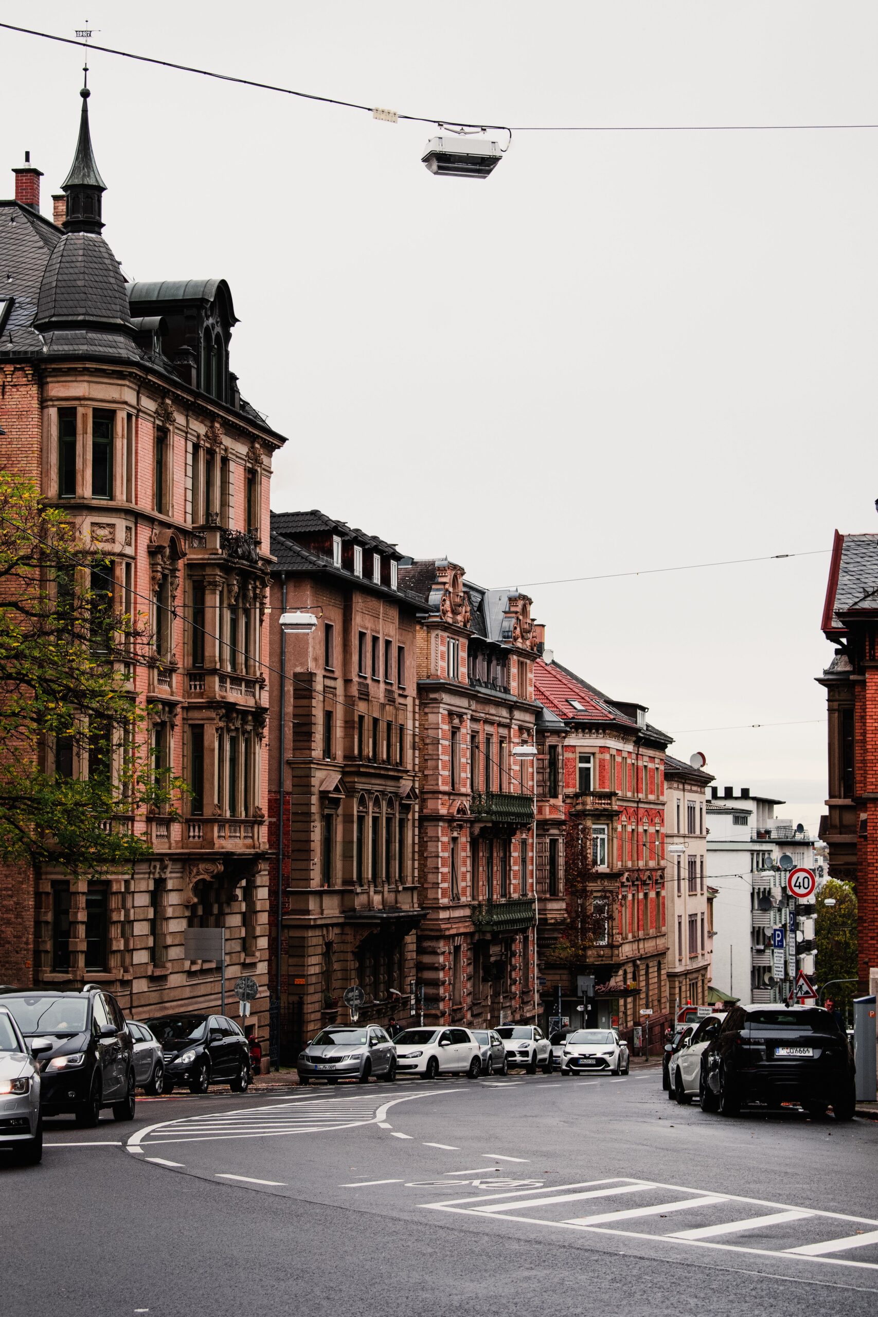 Historic Stuttgart street with ornate buildings and parked cars