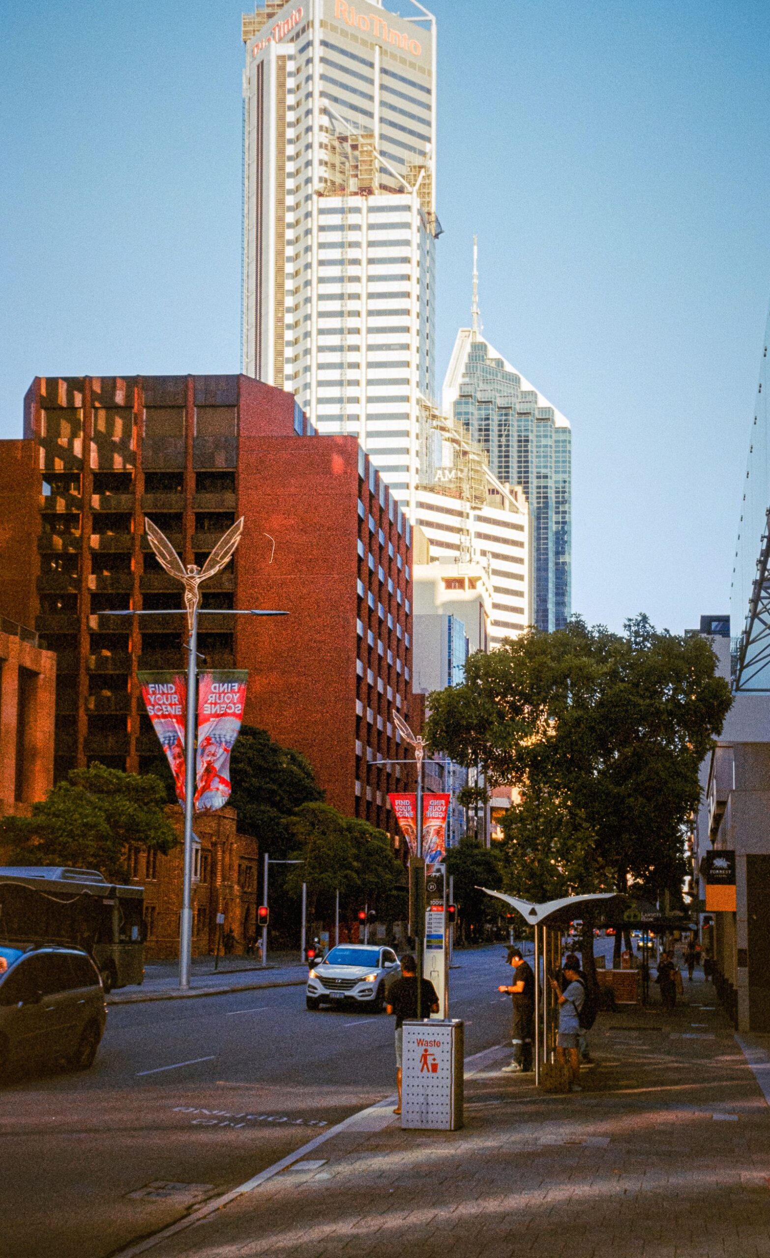Perth city street with office buildings, traffic and a pedestrian shelter