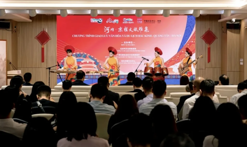 Musicians perform on stage before an audience at the Beijing–Guangxi–Hanoi tourism exchange in Hanoi.