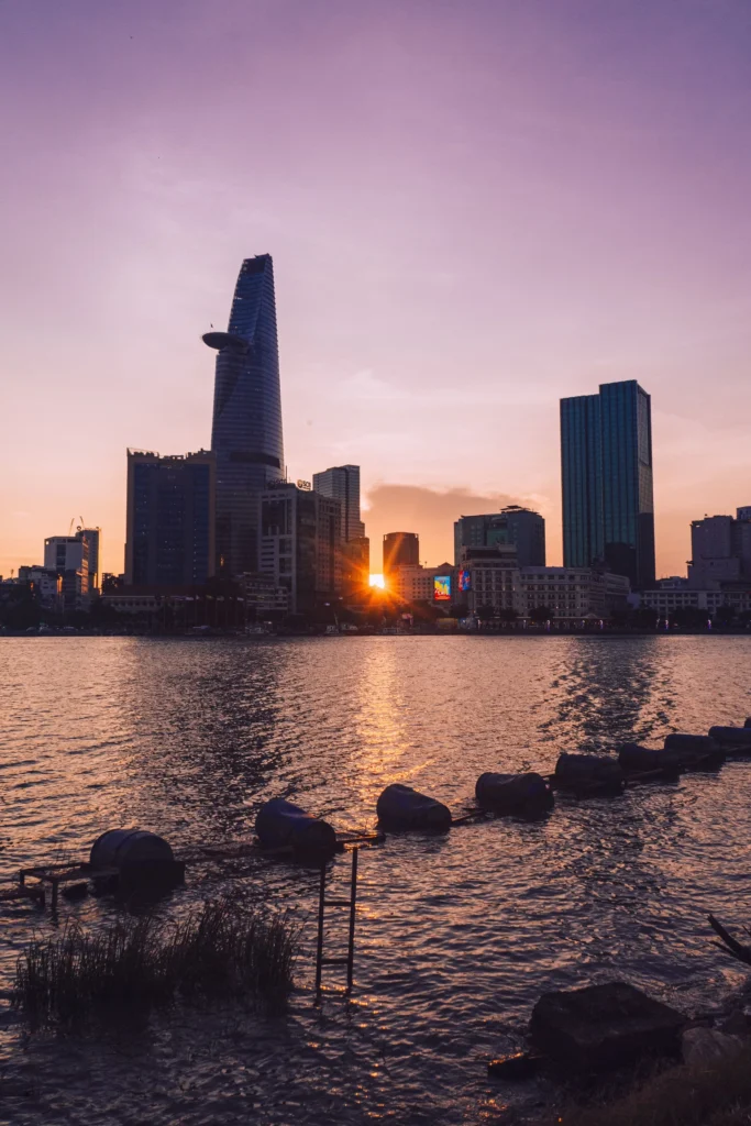 Ho Chi Minh City’s skyline, including Bitexco Tower, across the Saigon River at sunset.