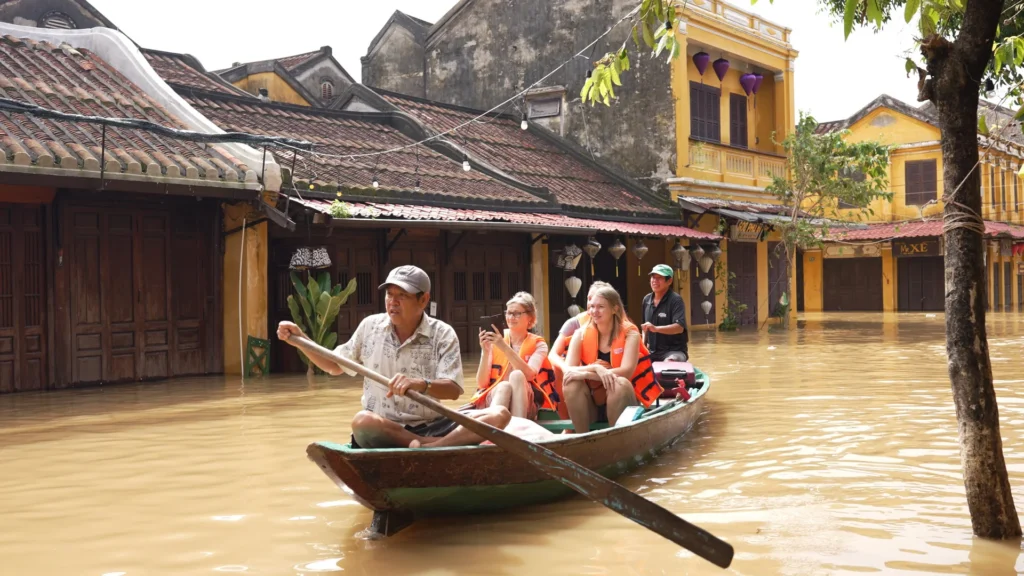 Visitors travel by boat through floodwater in Hoi An during the rainy season.