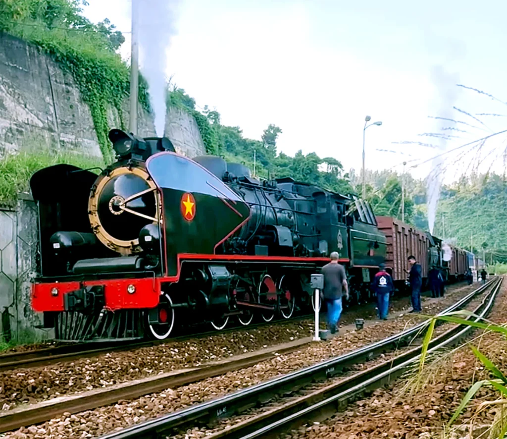 Restored steam locomotive and coupled carriages on the Hai Van Pass railway