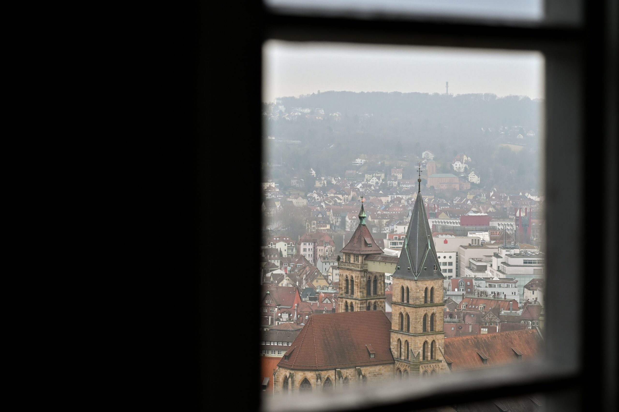 Stuttgart rooftops and church towers framed by a window