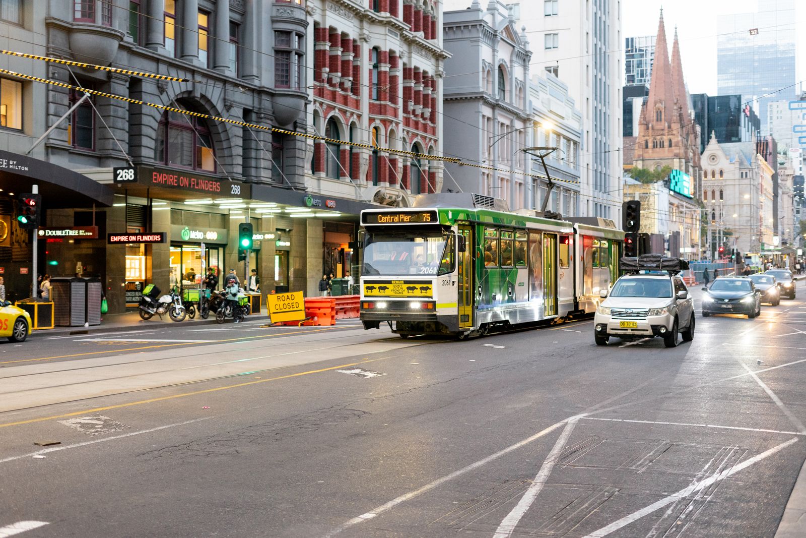 Melbourne tram on Flinders Street beside heritage buildings