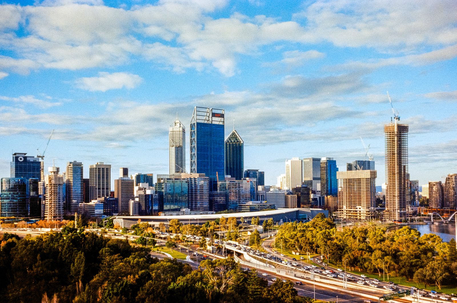 Perth CBD skyline with high-rise buildings, roads and trees