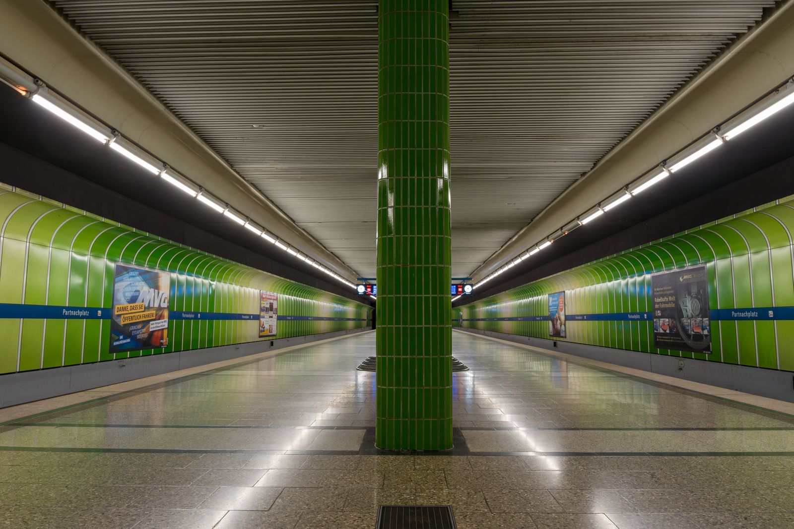 Empty Partnachplatz U-Bahn platform with green tiled walls