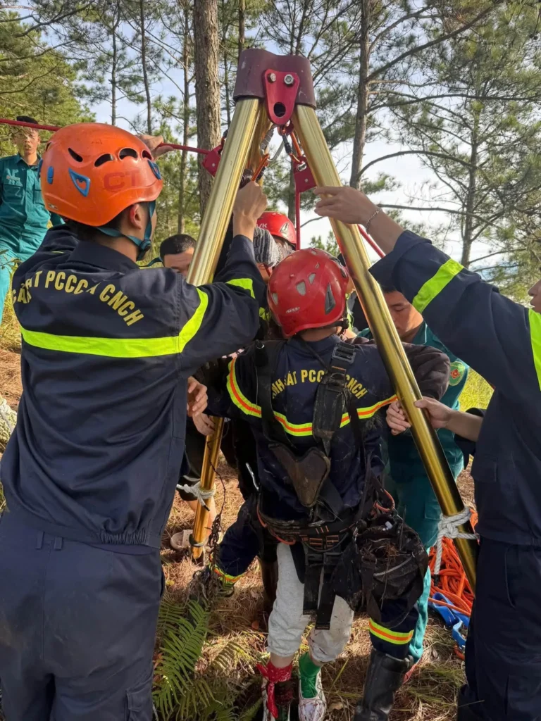 Rescue personnel help a hiker out of a hole in Da Lat.