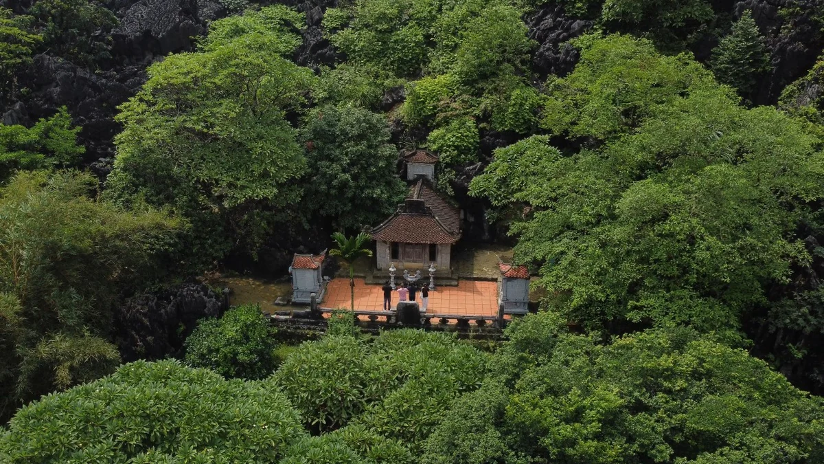 Pagoda buildings beneath a limestone hillside at Bich Dong