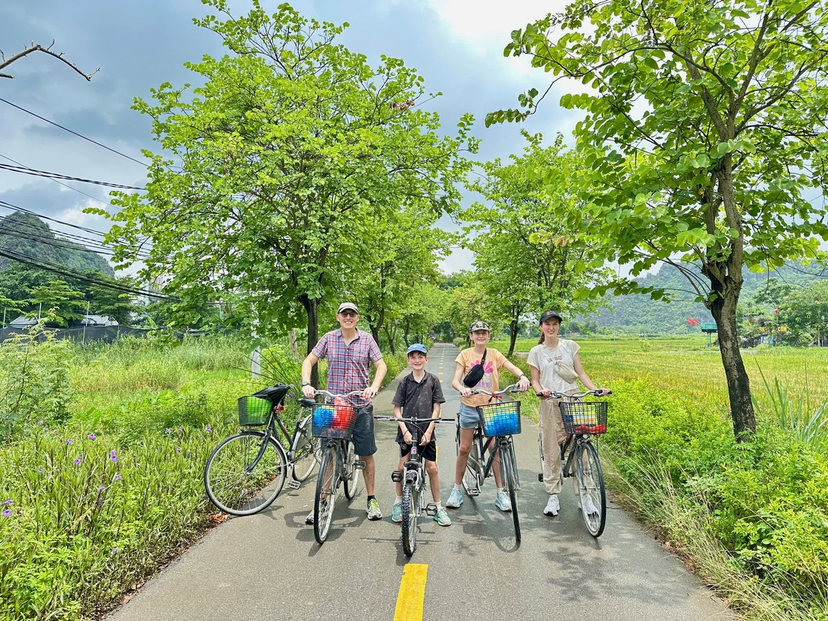 Guest group with bicycles against the Ninh Binh karst landscape