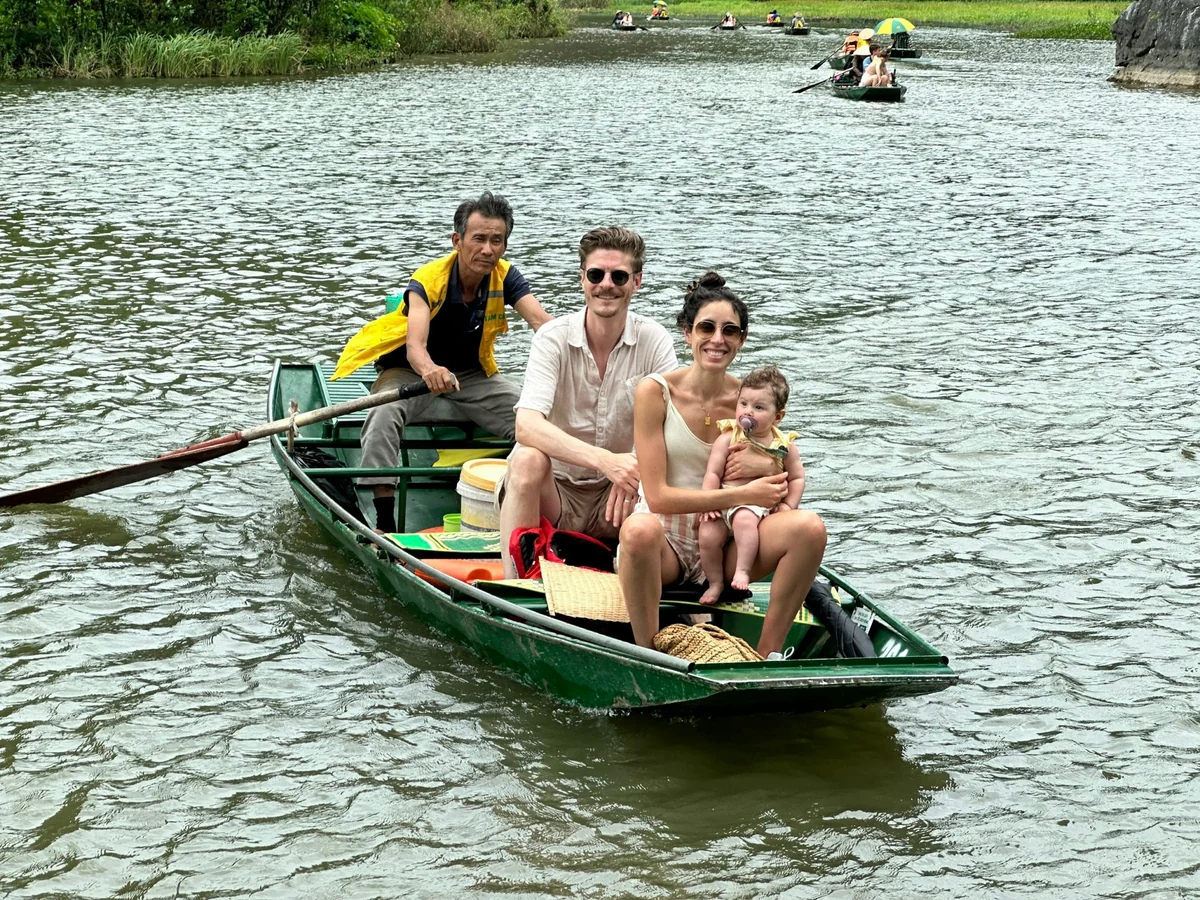 Family aboard a sampan in Tam Coc