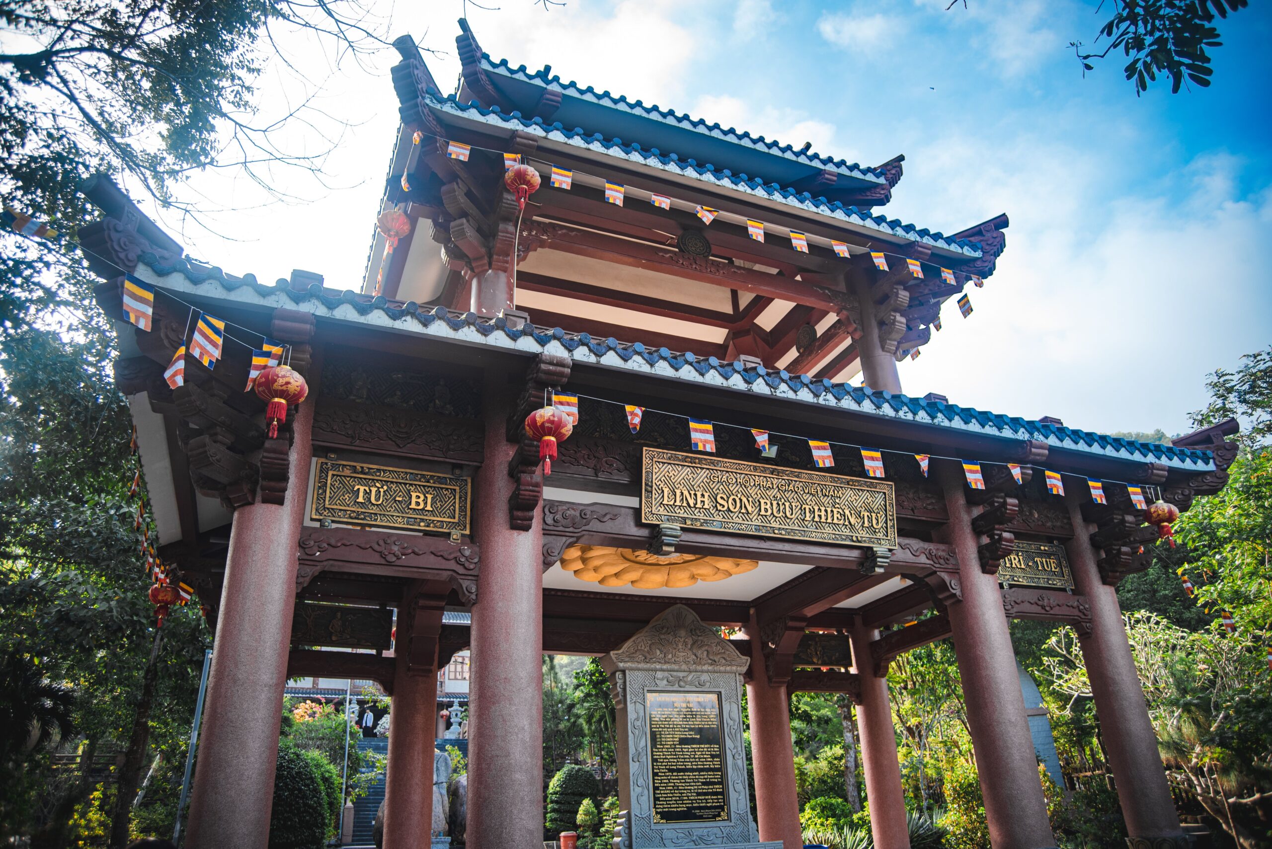 Vietnamese pagoda entrance with tiled roofs and carved wooden beams