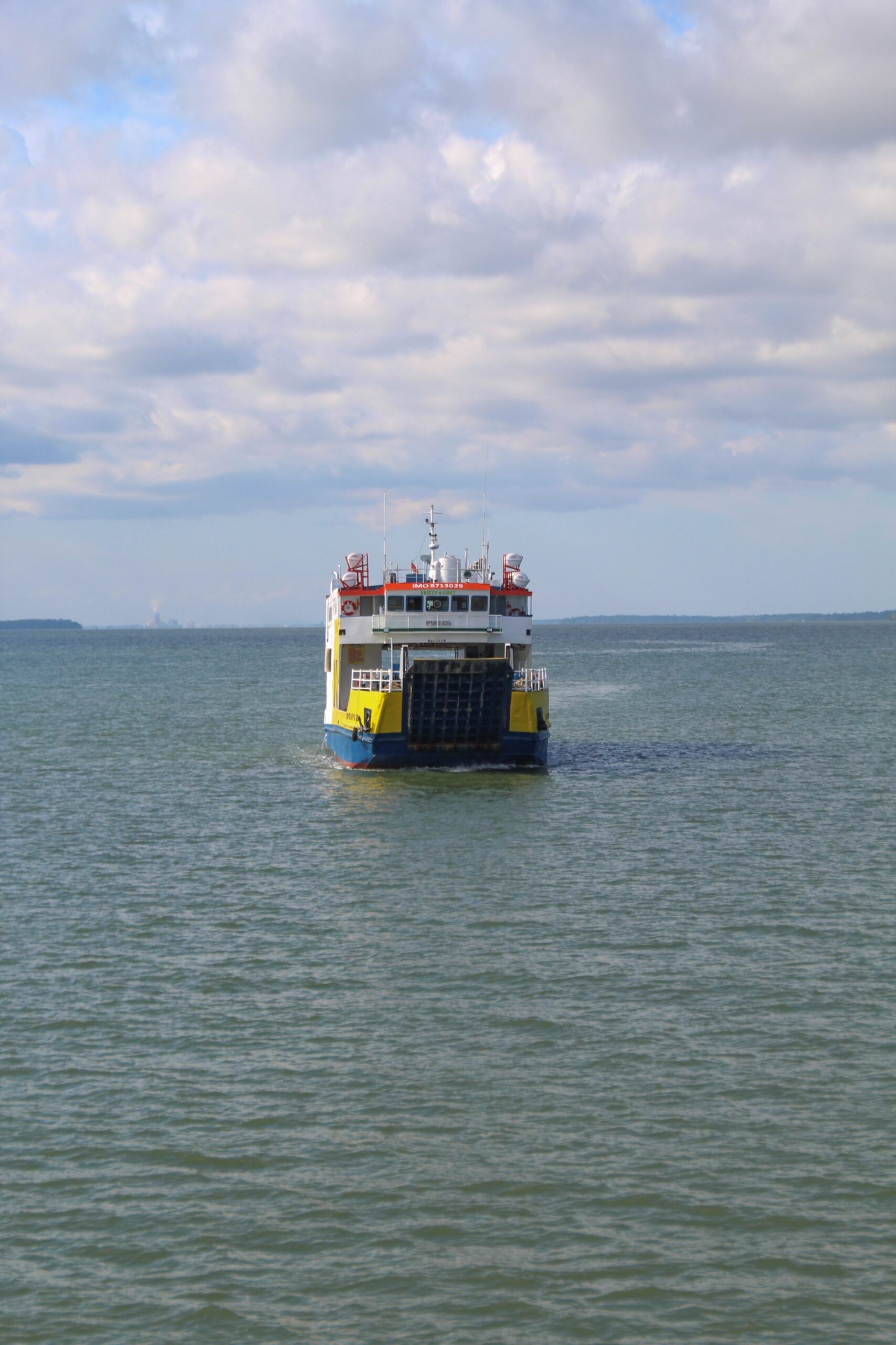 Ferry viewed from the stern with a broad loading ramp above the water