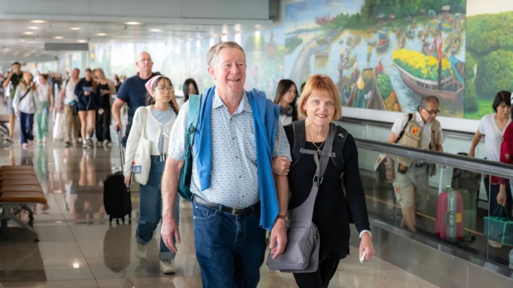 Passengers walk through an airport terminal.
