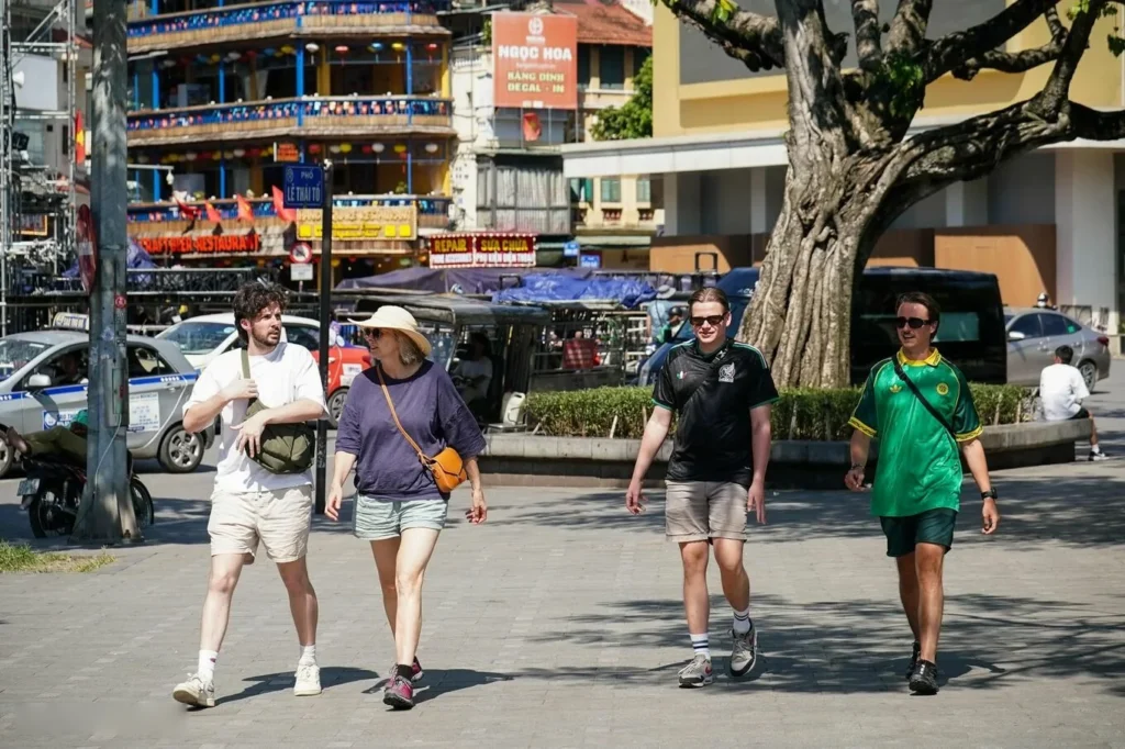 Tourists walk near Hoan Kiem Lake in Hanoi.