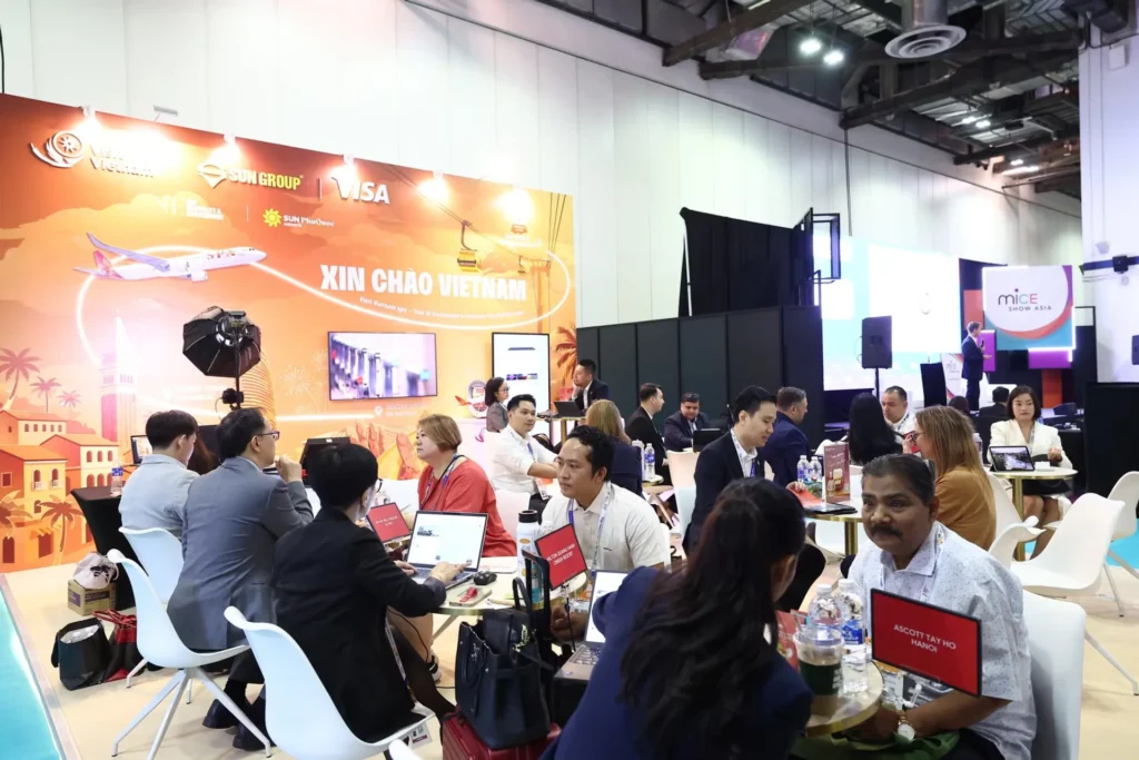 Visitors meet beneath the Visit Vietnam display at ITB Asia 2026 in Singapore.