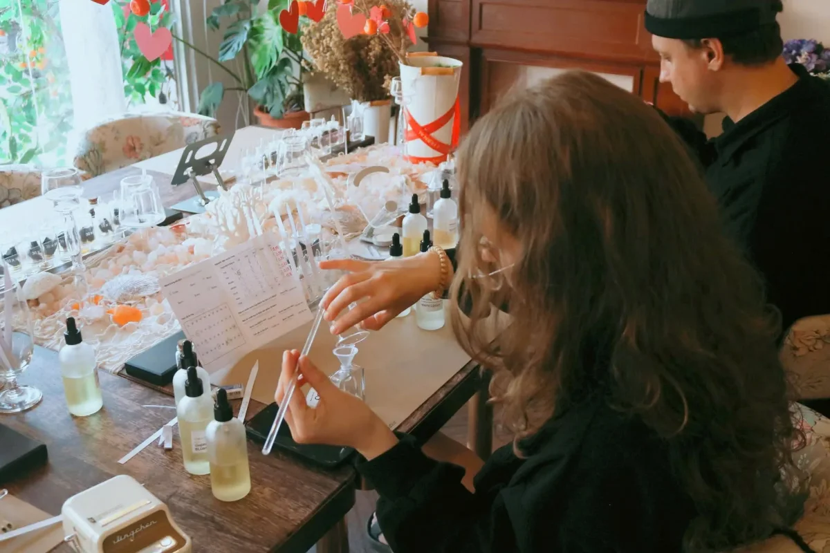 Fragrance bottles and blending tools arranged on the workshop table