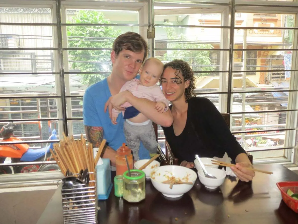 A family enjoying a meal during a Hanoi food tour