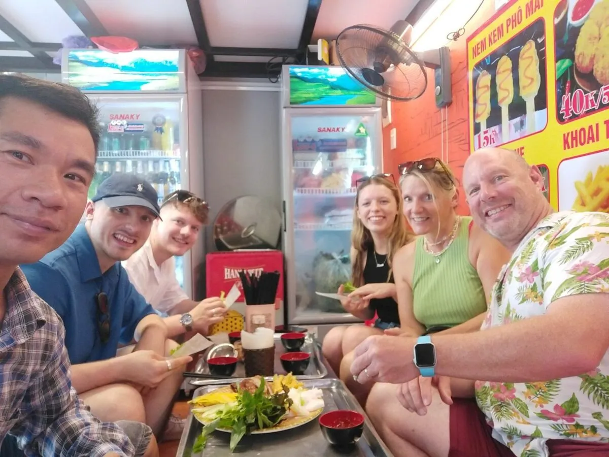 A guide and guests dining at a local restaurant in Hanoi