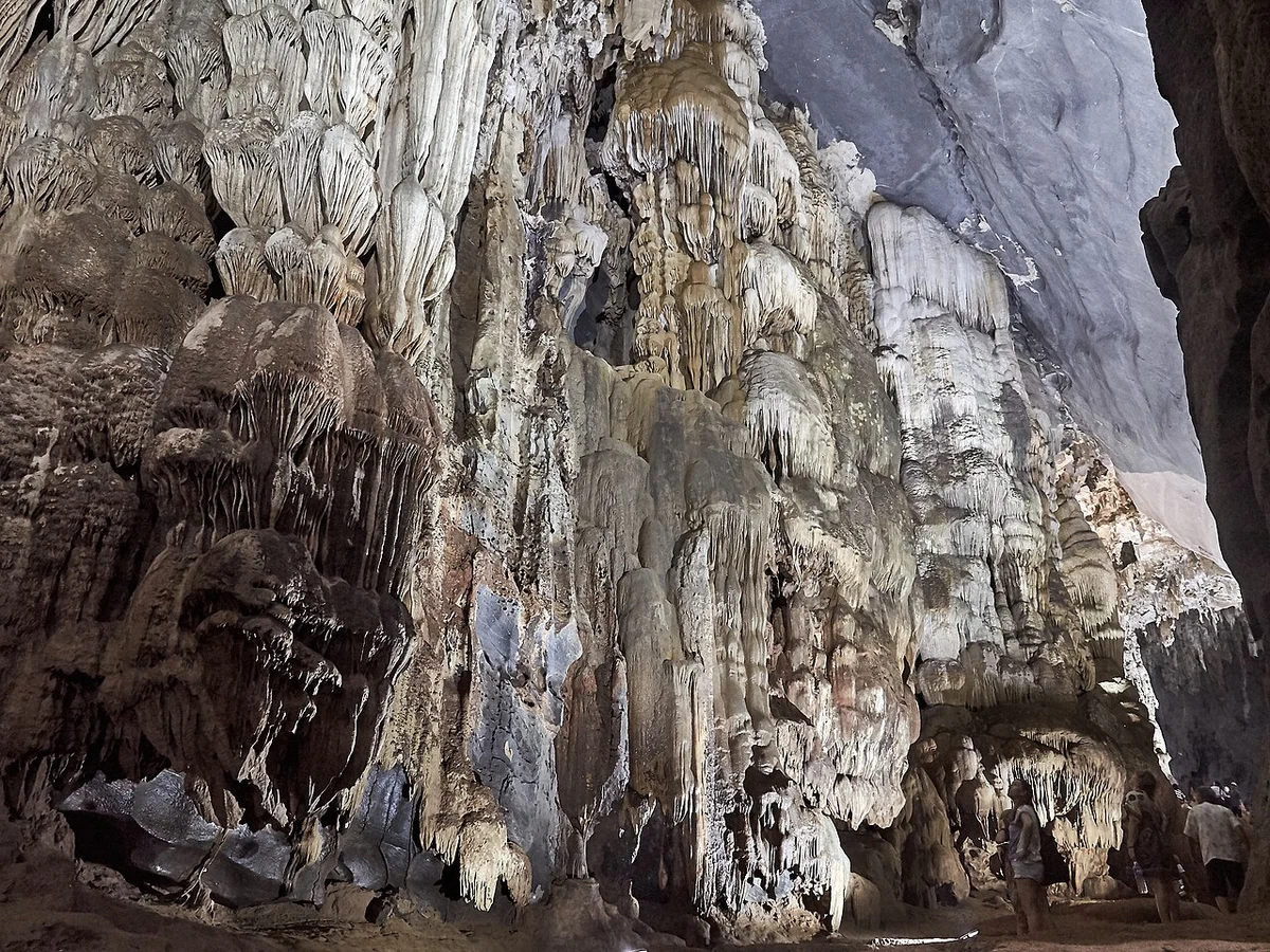 Layered limestone formations and hanging stalactites inside Phong Nha Cave.
